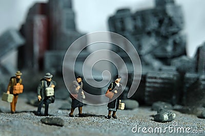 Miniature people toy figure photography. A group of refugee walking, moving in the middle of ruined demolish city, because of war Stock Photo