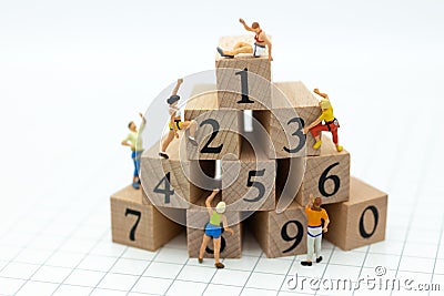 Miniature people: Traveler climbing to stack of number wooden block . Image use for healthy , exercise concept Stock Photo