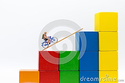 Miniature people : Traveler use the bicycle with takes the ladder from one place to another. Image use for travel, Stock Photo