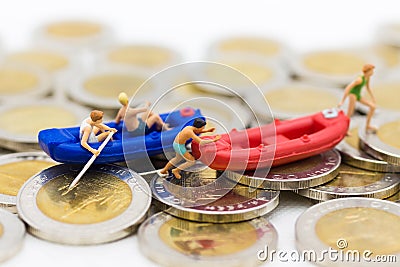 Miniature people : Travelers with paddle boat on coins. Image use for activities, travel business concept Stock Photo