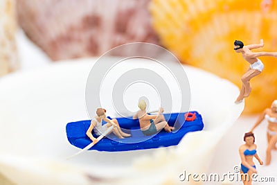 Miniature people : Travelers with paddle boat . Image use for activities, travel business concept Stock Photo