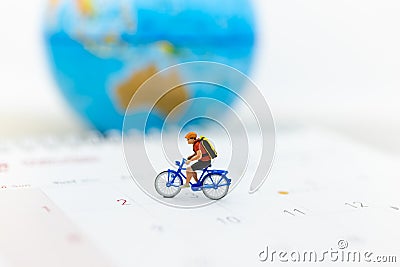 Miniature people : Travelers riding bicycle around the world. Image use for background traveling , business concep Stock Photo
