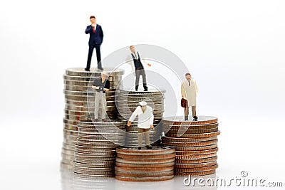 Miniature people with various occupations standing on coins money Stock Photo