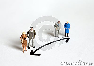 Miniature people who stand in a different direction. Stock Photo