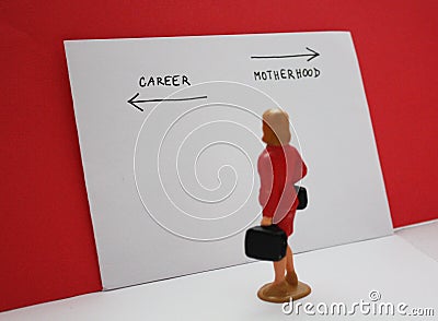 Miniature people, woman decides between a career and a child. Bilogical clock, feministmambitions, job or family dilemma Stock Photo