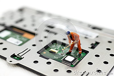 Miniature people: Worker repairing circuit board ,electronics repair. Use image for support and maintenance business Stock Photo