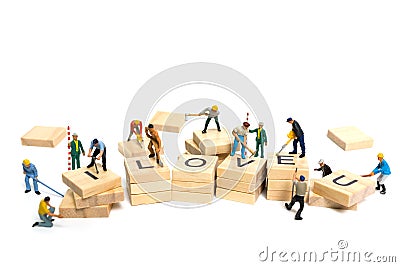 Miniature people : Worker team building word ` Love ` on wooden block Stock Photo