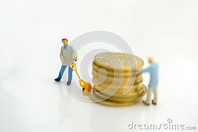 Miniature people: Worker transportation golden coin Stock Photo