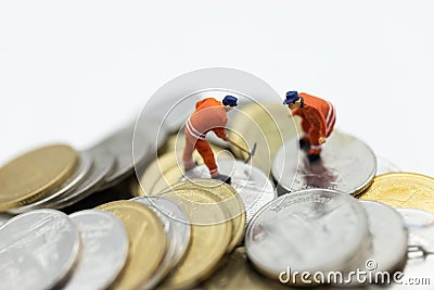 Miniature people: Worker working on stack of coins, income from work. Image use for business concept Stock Photo