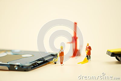 Miniature people: Workers moving circuit board for repair Stock Photo
