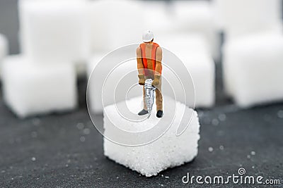 Miniature people Working with sugar. Health care concept. Stock Photo