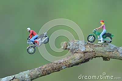 Miniature person figure of a rider motor cycle in the park / toys kids Stock Photo