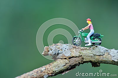 Miniature person figure of a rider motor cycle in the park / toys kids Stock Photo