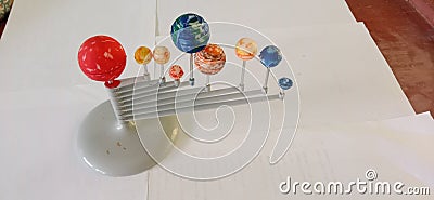 Miniature planet Earth with the arrangement of the sun, Venus, Mars, Earth, Jupiter, Saturn, Uranus, Neptune and Pluto. Stock Photo