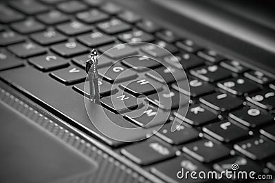 Miniature policemen inspecting laptop. Piracy and internet web hacking concept Stock Photo