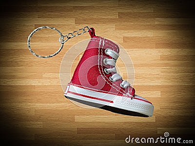 Miniature red baskeball shoe on wooden floor as background Stock Photo