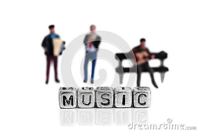 Miniature scale model musicians standing behind the word music Stock Photo