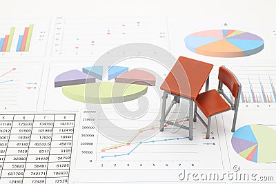 Miniature school study desk and documents with charts and graphs. Stock Photo