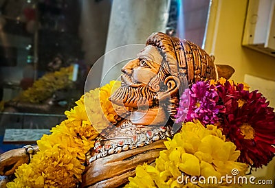 Miniature sitting Statue of Famous king Shivaji in India with selective focus on the face and background blur Stock Photo