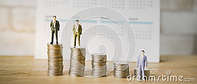 miniature of standing business man with row of coins and calendar Stock Photo