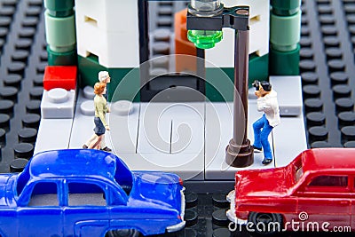 Miniature tiny toys paparazzi were taken secretly the couple. Stock Photo