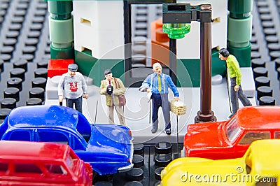 Miniature tiny toys people waiting to cross the road. Stock Photo