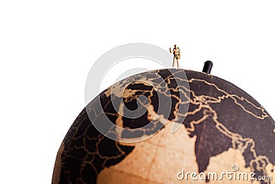 Miniature tourist on top of the globe. Travel concept Stock Photo
