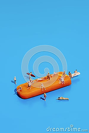 miniature vacationers on an orange popsicle Stock Photo