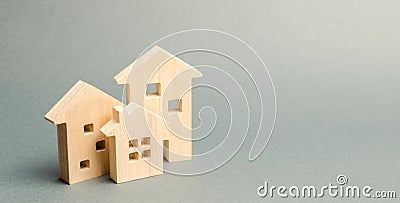 Miniature wooden houses on a gray background. Real estate. Long-term rental apartments. Affordable housing for young families. Stock Photo