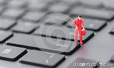 Miniature of a worder deciding to take a carreer shift, a concept with shift keyboard button Stock Photo