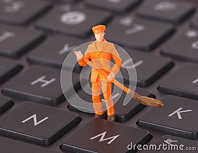 Miniature worker is cleaning a keyboard Stock Photo