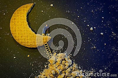 Miniature worker repairing the half moon Stock Photo