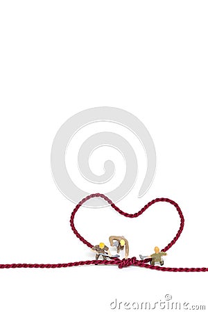 Miniature worker team building Heart Shaped with rope Stock Photo