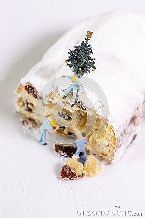 Miniature Workers breaking pieces of raisins and cake Stock Photo