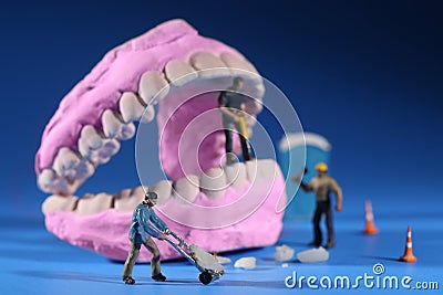 Miniature Workers Performing Dental Procedures. Dental Office Ar Stock Photo