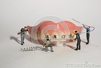 Miniature Workers Performing Dental Procedures. Dental Office Ar Stock Photo