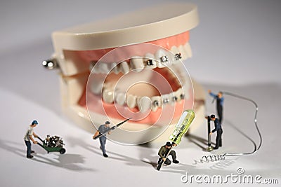 Miniature Workers Performing Dental Procedures. Dental Office Ar Stock Photo