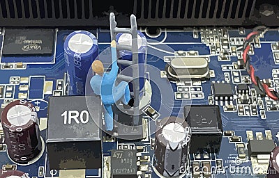 Miniature workers and piece of computer interior hardware Editorial Stock Photo