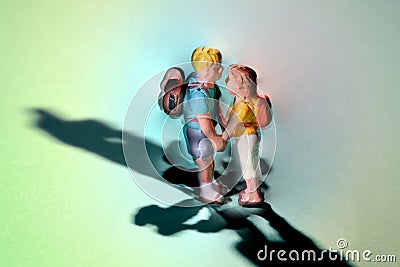 Miniature young couple in love standing holding hands Stock Photo