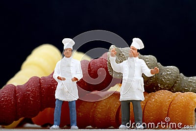 Miniatures of chef with pasta Stock Photo