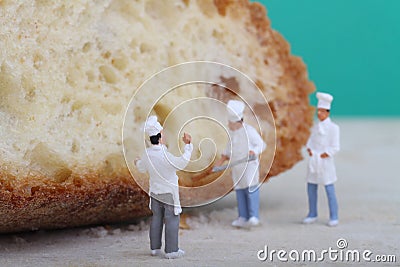 Miniatures of cooks with bread Stock Photo