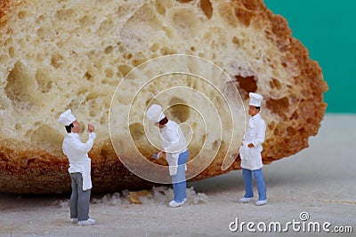 Miniatures of cooks with bread Stock Photo