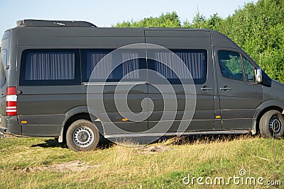 Minibus in motion on a background of mountains Stock Photo