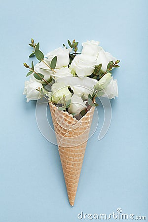 Minimal composition with creative ice cream of beautiful flowers on blue pastel paper top view. Flat lay style. Stock Photo