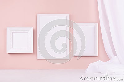 Minimal elegant gallery for display portfolio - three blank rectangle photo frames with flow silk curtain hanging on pink wall. Stock Photo