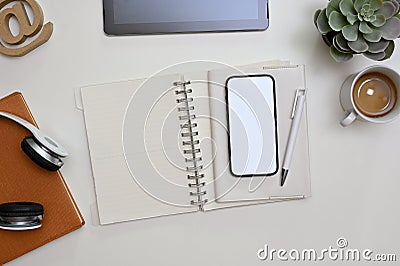 Minimal office desk workspace top view with smartphone mockup, stationery and decor Stock Photo