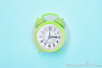 Minimalism green room alarm clock on a blue background copy Stock Photo