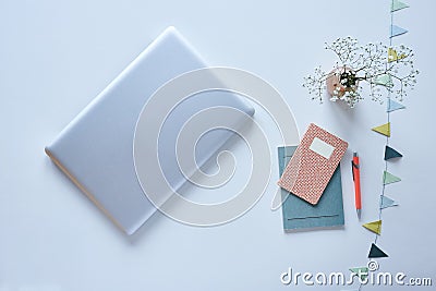 Minimalist blogger desktop laptop and pastel accessoires with flowers Stock Photo