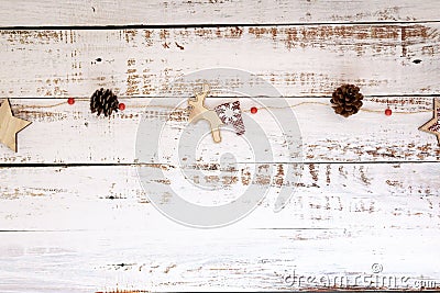 Minimalist Christmas garland of reindeer stars and pine cones on white wood background. New year and Christmas concept Stock Photo