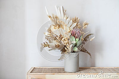 Minimalistic composition of dried flowers in cylindrical ceramic vase Stock Photo